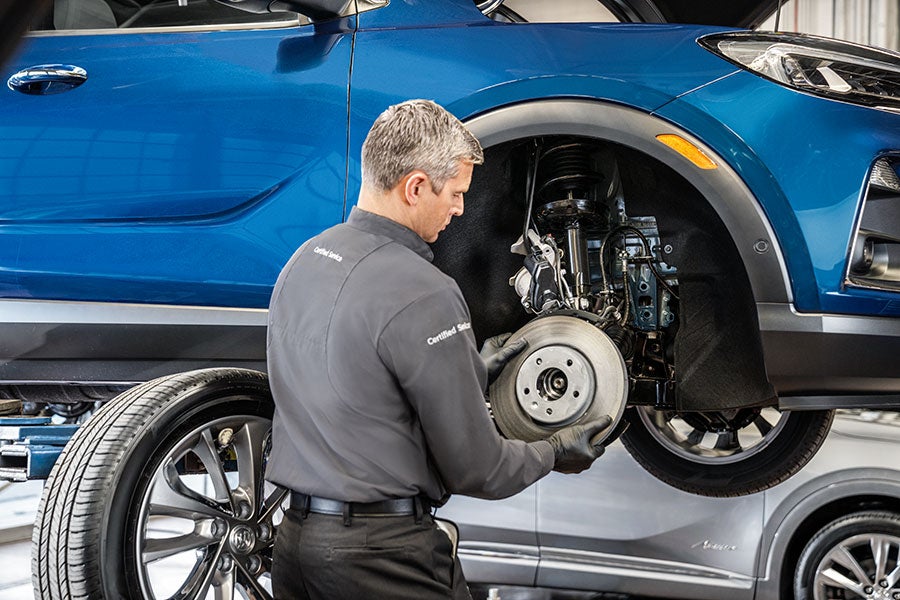 Service technician changing brake pads